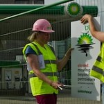 Demonstrators hang signs on a fence they have used to barricade a BP station in London, July 27, 2010. (AFP/Getty Images)
