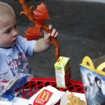Dylan Maki, 4, of Evanston, plays with his Happy Meal toy outside of the McDonald's at Navy Pier on July 7, 2010. (William DeShazer/Chicago Tribune)