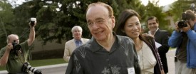 Rupert Murdoch, seen here with his wife Wendy Deng in 2007, was quizzed Friday over News Corp.'s political donations. (AP Photo/Douglas C. Pizac)
