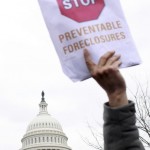 In this Mar. 10, 2009 file photo, victims of foreclosure and their supporters take part in a rally on Capitol Hill in Washington. (AP Photo/Lauren Victoria Burke, file)