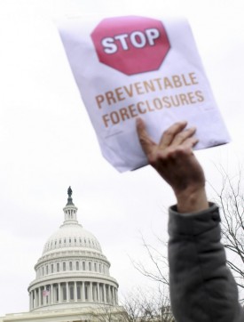 In this Mar. 10, 2009 file photo, victims of foreclosure and their supporters take part in a rally on Capitol Hill in Washington. (AP Photo/Lauren Victoria Burke, file)