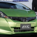 Honda CEO Takanobu Ito poses next to the company's all-new Fit Hybrid car during its unveiling in Tokyo Oct. 8, 2010. (Reuters/Issei Kato)