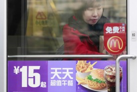 A woman walks out of a McDonald's outlet in Beijing Nov. 17, 2010. (Christina Hu/Reuters)
