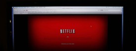 A movie selected from among Netflix's "Watch Instantly" titles begins to download on a home computer screen in New York, Nov. 22, 2010. (AP Photo/James H. Collins)