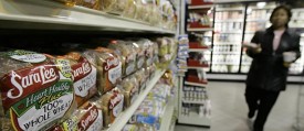 A shopper passes shelves of Sara Lee bread at a Chicago market on Monday, Nov. 5, 2007. Food maker Sara Lee Corp. said Wednesday its fiscal first-quarter profit fell 40 percent due to higher commodity costs and an increase in marketing and advertising spending. (AP Photo/M. Spencer Green)