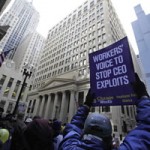 Though the Treasury's bailout of AIG caused controversy, an offering of AIG stock could come as early as March. Here, workers protest outside of AIG's Chicago offices in 2009. (AP Photo/Spencer Green)