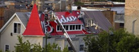 A Budweiser ad on a Wrigley rooftop on Waveland is removed in September of 2008 to make way for a Horseshoe Casino ad, which will soon be replaced by one for United. (Phil Velasquez/Tribune)