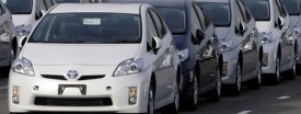 Workers walk between newly assembled Prius hybrid vehicles near Toyota's plant in central Japan, Feb. 9, 2010. (Reuters/Yuriko Nakao/Files)