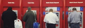 Customers use ATMs at a Bank of America branch in Boston. (AP Photo/Lisa Poole)