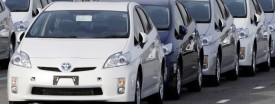 Workers walk between newly-assembled Prius vehicles near Toyota's plant in Toyota, central Japan, in this February 9, 2010 file photo. (Reuters/Yuriko Nakao/Files)
