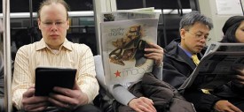 A commuter reads on a Kindle e-reader while riding the subway in Cambridge, Mass. (Reuters/Brian Snyder)